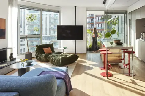 Spacious luxury living room in a designer apartment for rent in the Gindi TLV project, featuring modern architectural design, open space layout, and high‑end finishes.