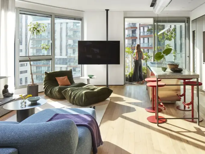 Spacious luxury living room in a designer apartment for rent in the Gindi TLV project, featuring modern architectural design, open space layout, and high‑end finishes.
