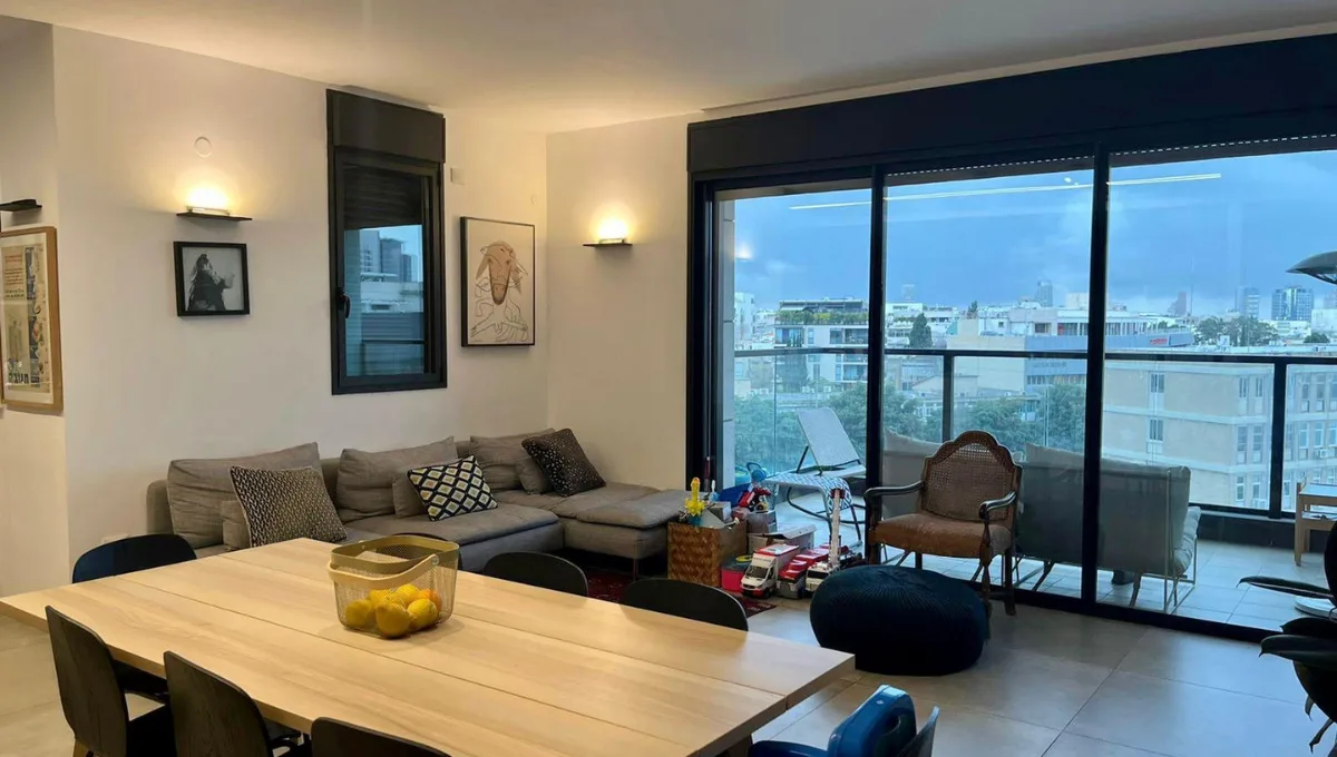 Spacious living room with natural light in a boutique Gindi Tel Aviv apartment for sale